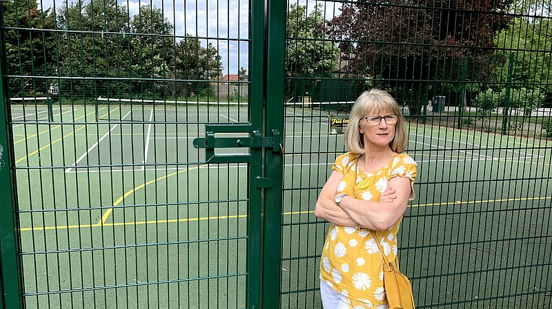 Cllr Gould outside one of the tennis courts affected